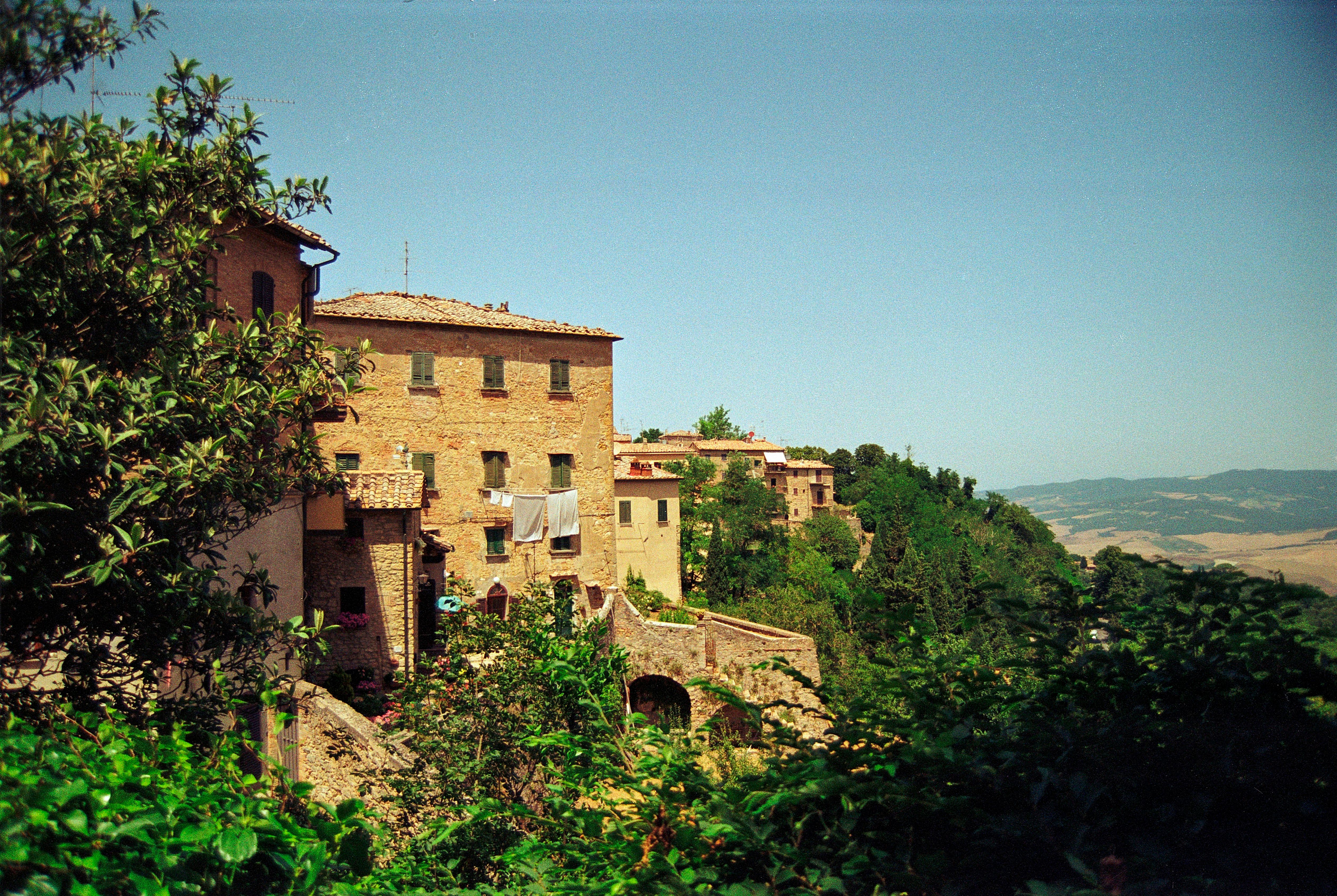 a building on a hill surrounded by trees