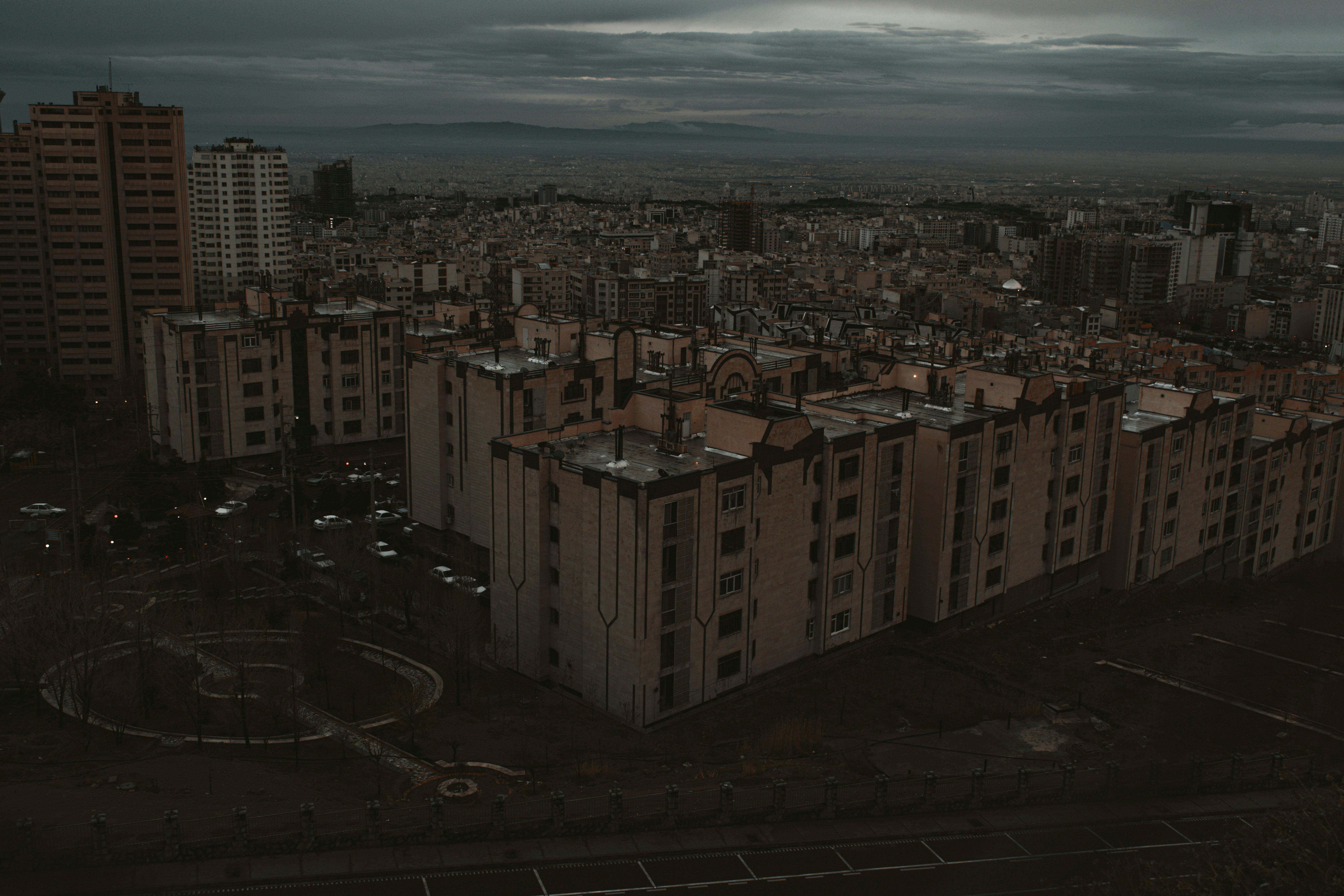 Overhead view of a city under a cloudy sky.