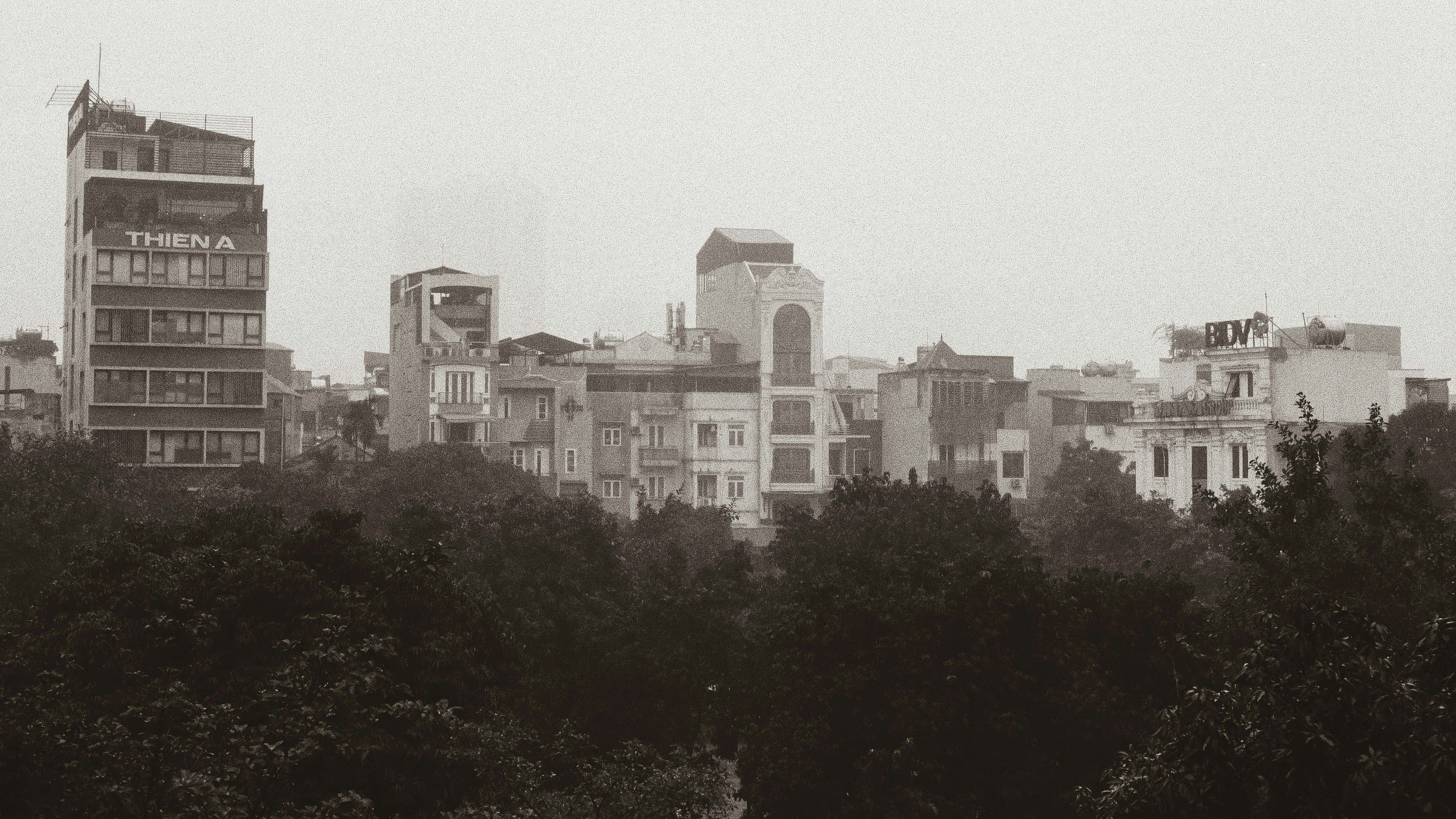 City skyline with buildings and trees.
