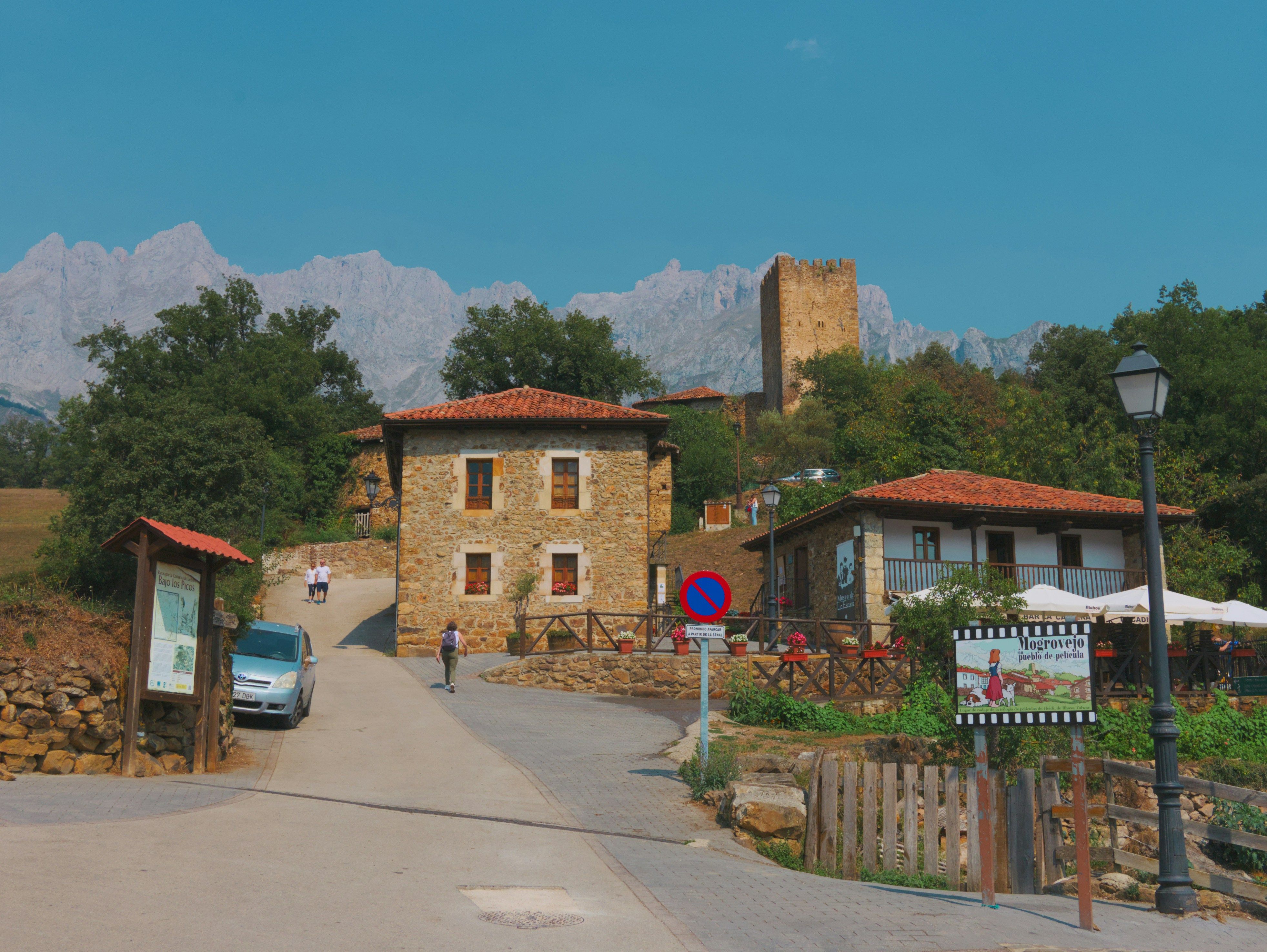 Historic european village with stone buildings and mountains.