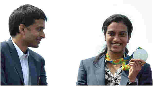 P. V. Sindhu with coach P. Gopichand and her silver medal from the 2016 Rio Olympics