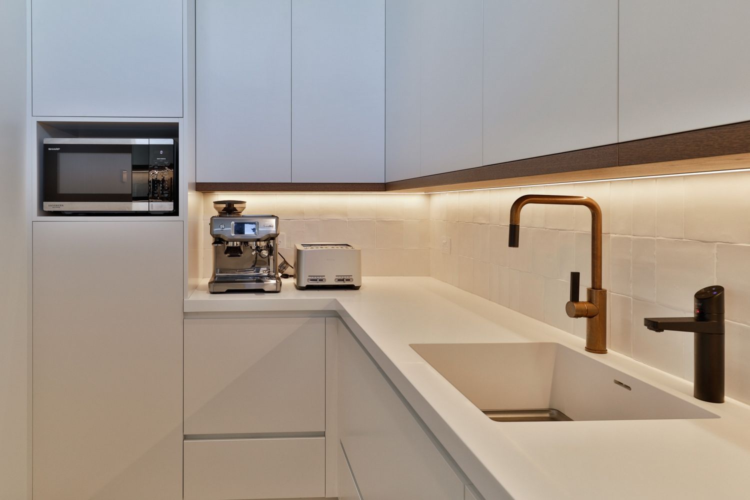Close up view into the scullery, carrying through the kitchen detailing and on bench appliances.