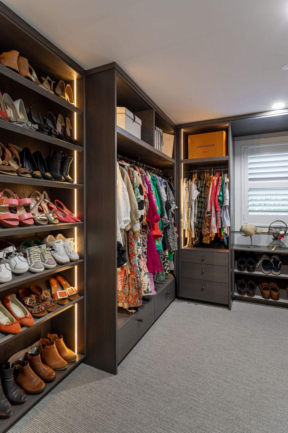 custom walk in wardrobe Auckland with LED shoe shelving and dark oak veneer cabinetry