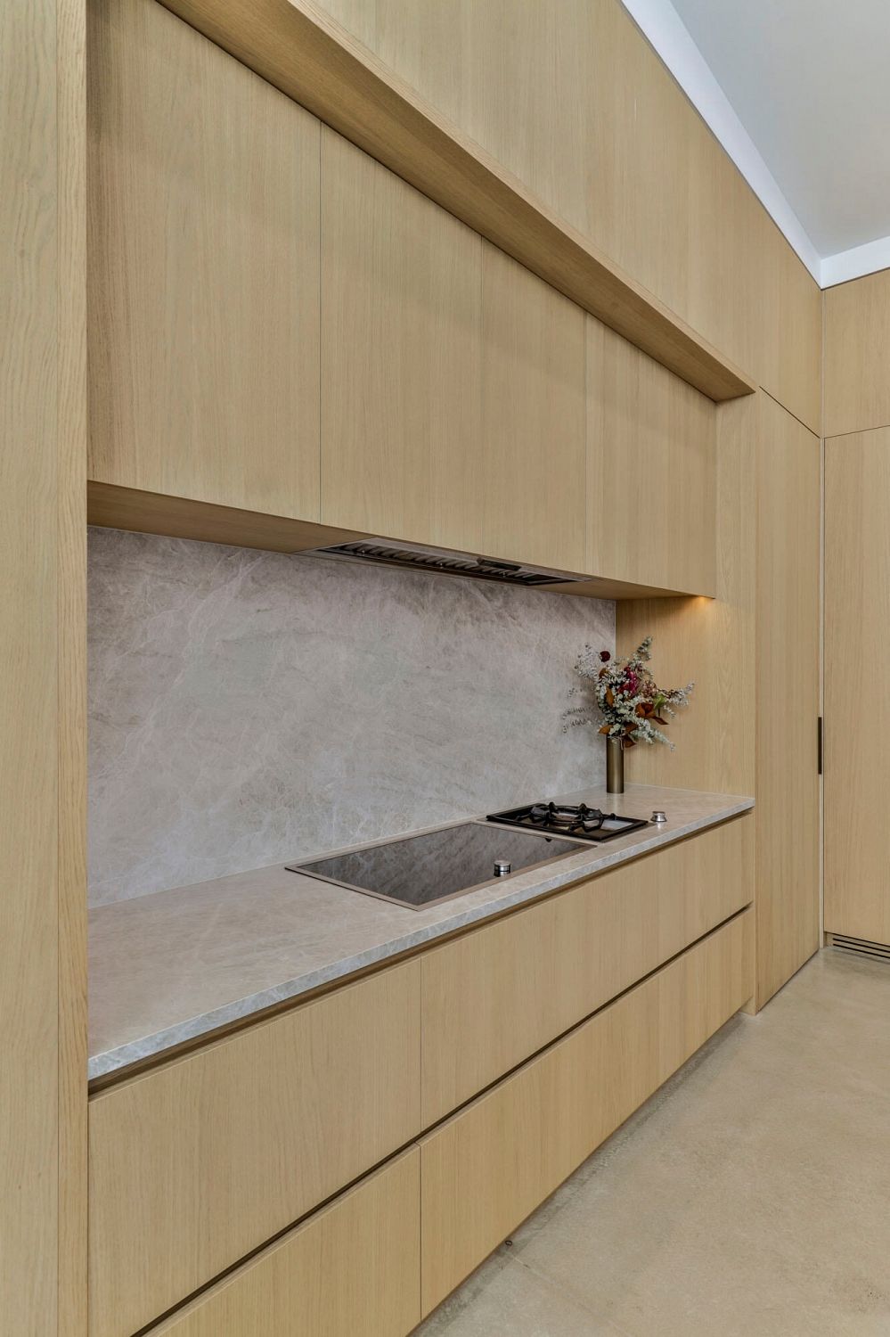 Warm timber kitchen contrasted with polished concrete flooring