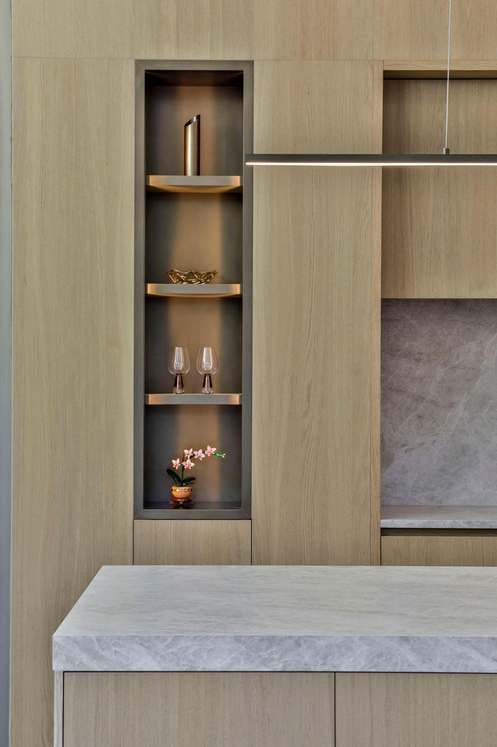 Bespoke brass shelving detail integrated into full-height timber cabinetry
