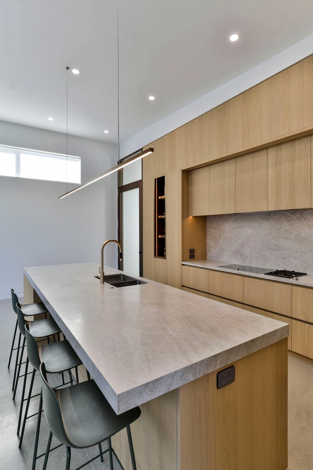 View of kitchen highlighting proportion, alignment, and material continuity