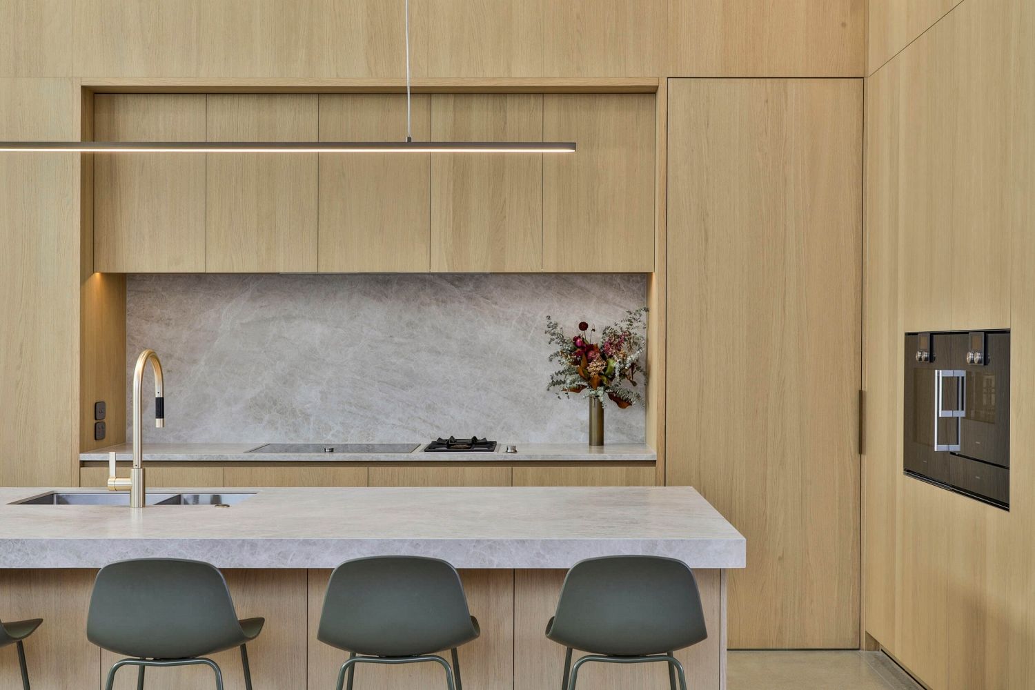 Concealed storage wall with integrated appliances and clean detailing