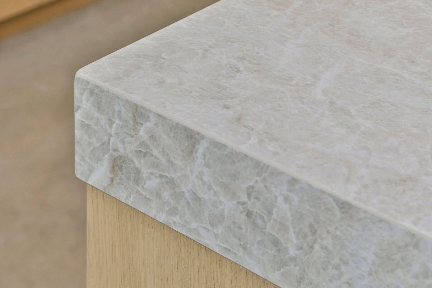 Detail view of island benchtop stone surface with organic veining pattern