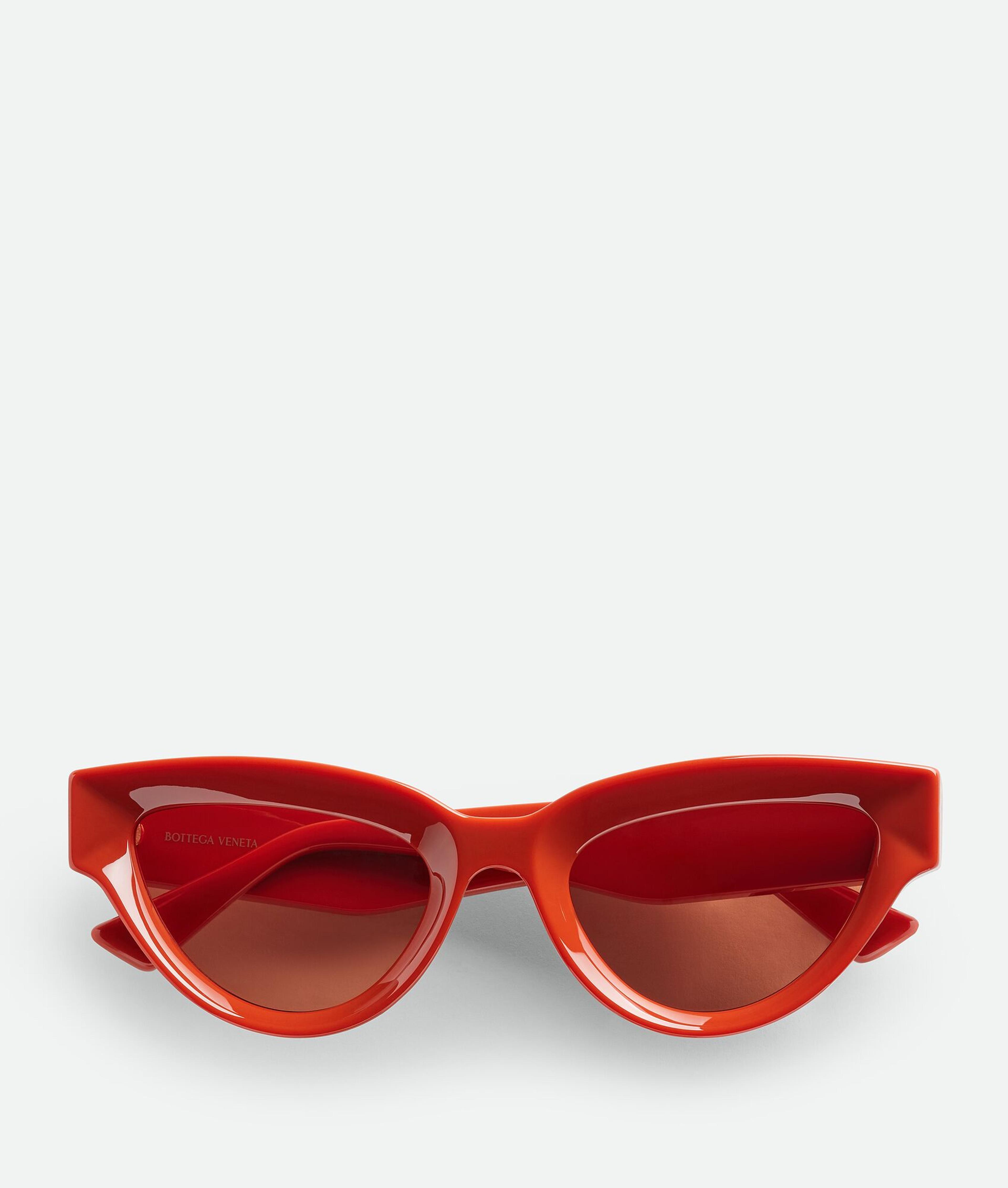 Bottega Veneta® Women's Sharp Cat Eye Sunglasses in Orange / Brown. Shop online now.