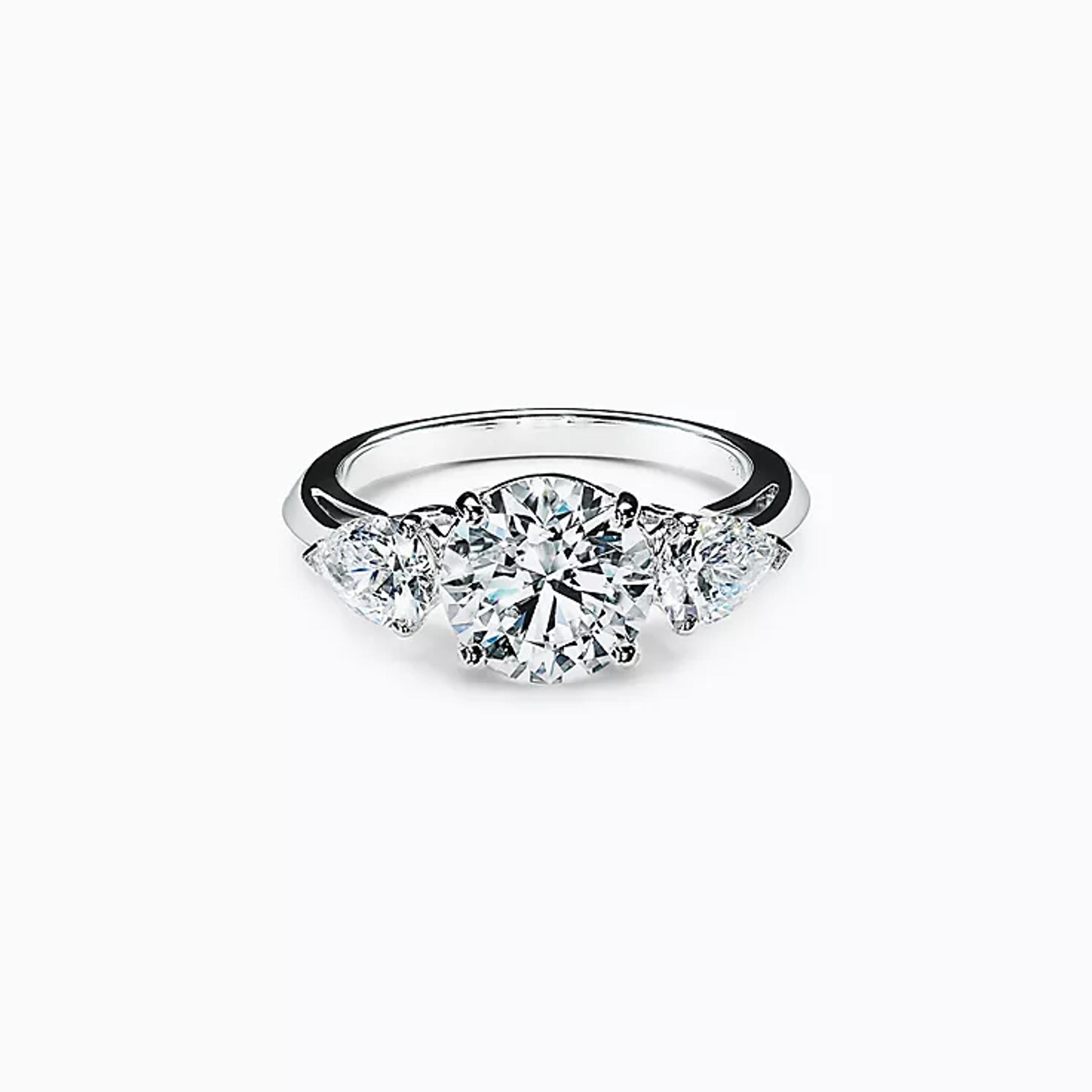 Tiffany Three Stone engagement ring with pear-shaped side stones in platinum. | Tiffany & Co.