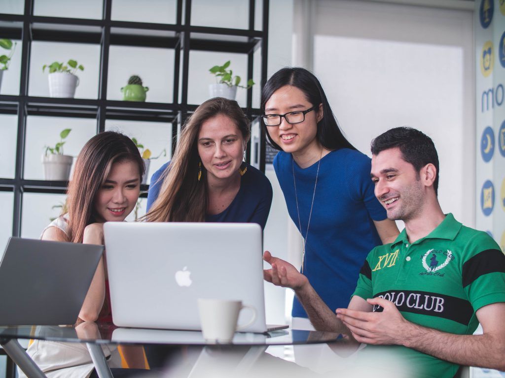 People sharing ideas with the help of a MacBook laptop—a benefit of typing.