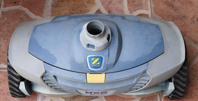 Screenshot 2026-04-15 105009 Am - Diy Pool Resources - Inyopools.com Blue and gray Zodiac MX8 robotic pool cleaner on terracotta tiles, showing the intake opening and wheels.