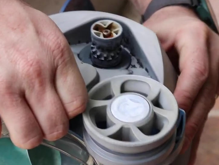 Screenshot 2026-04-23 92849 Am - Diy Pool Resources - Inyopools.com Close-up of hands attaching a burner to a portable camping gas canister for a stove use