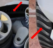 Close-up of two vent-like openings with a red arrow pointing to a gap or misalignment between parts, suggesting a potential issue on a mechanical assembly.