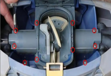 Close-up of an open blue device showing its inner mechanism with several bolts circled in red for emphasis, including a central beige component and surrounding metal frame.