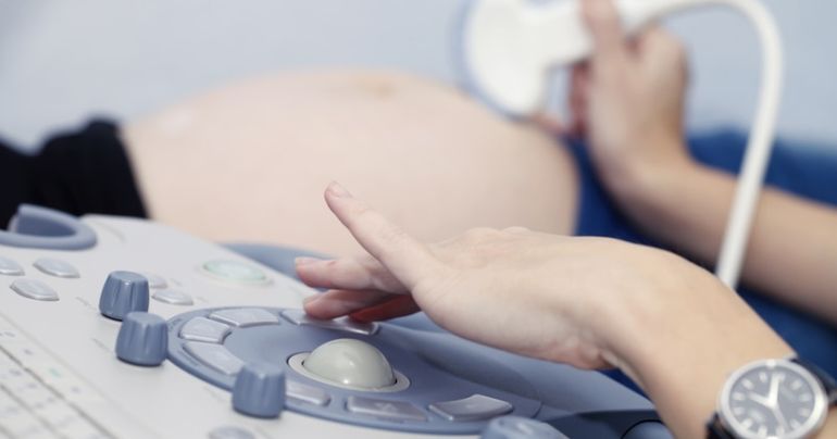 Pregnant girl doing on ultrasound examination