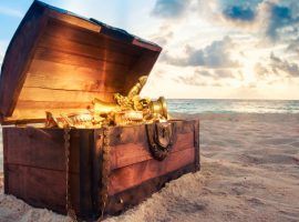 Open treasure chest on the beach