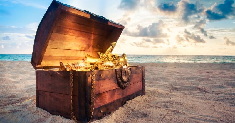 Open treasure chest on the beach