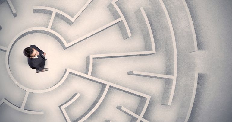 Business man trapped in a circular maze