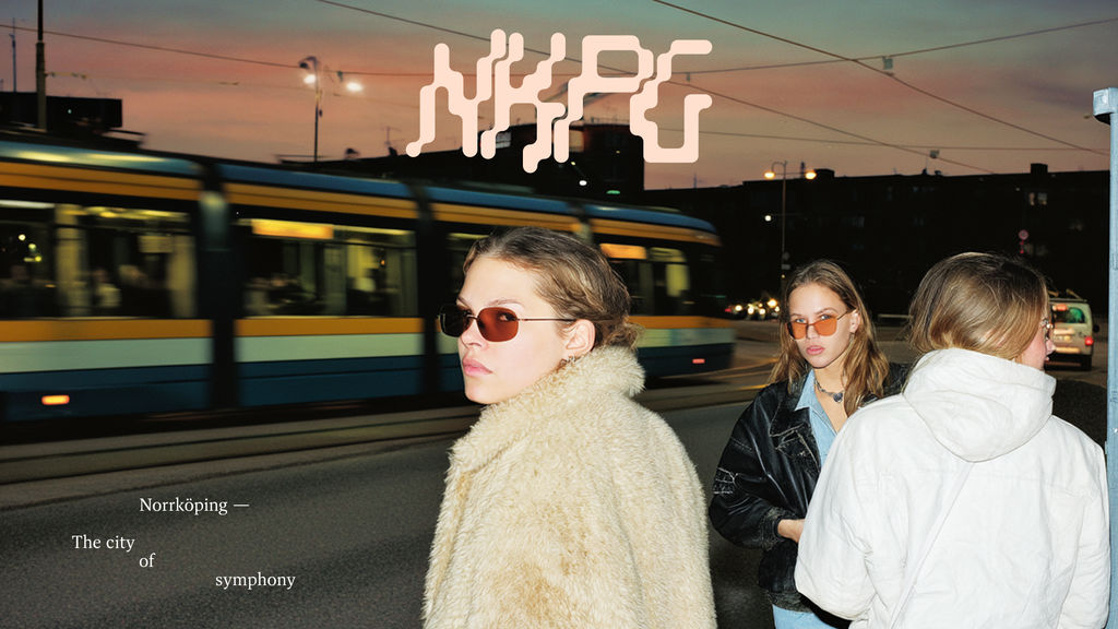 A key visual generated by Johanna Åkeson showing youths approaching a subway train and text that reading "Norrköping The City of Symphony".