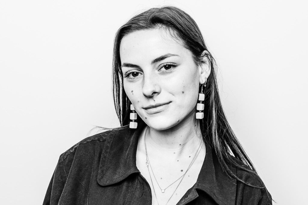 A grayscale portrait picture of Line Jess smiling at the camera