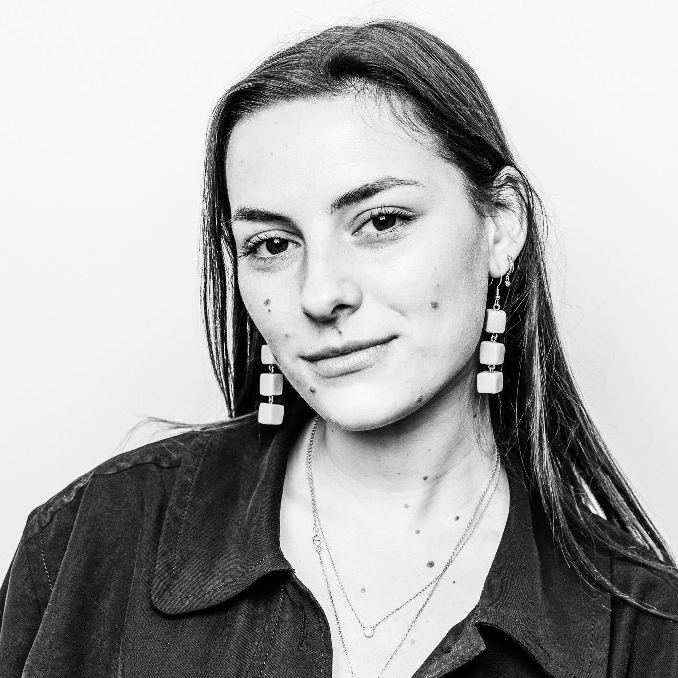A grayscale portrait picture of Line Jess smiling at the camera