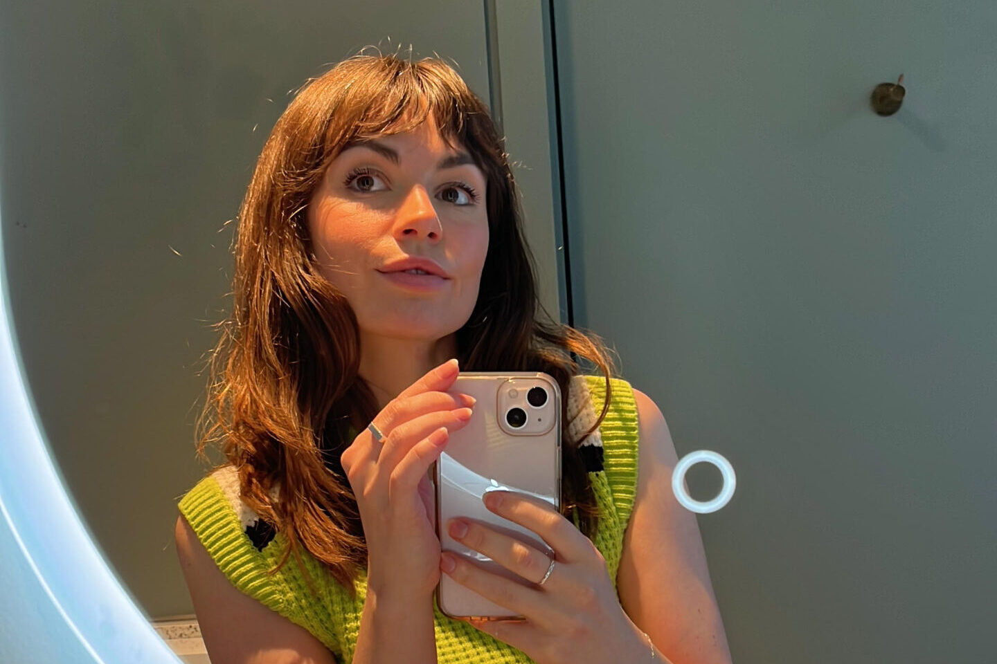 Imogen Comrie taking a picture of her reflection in a mirror.