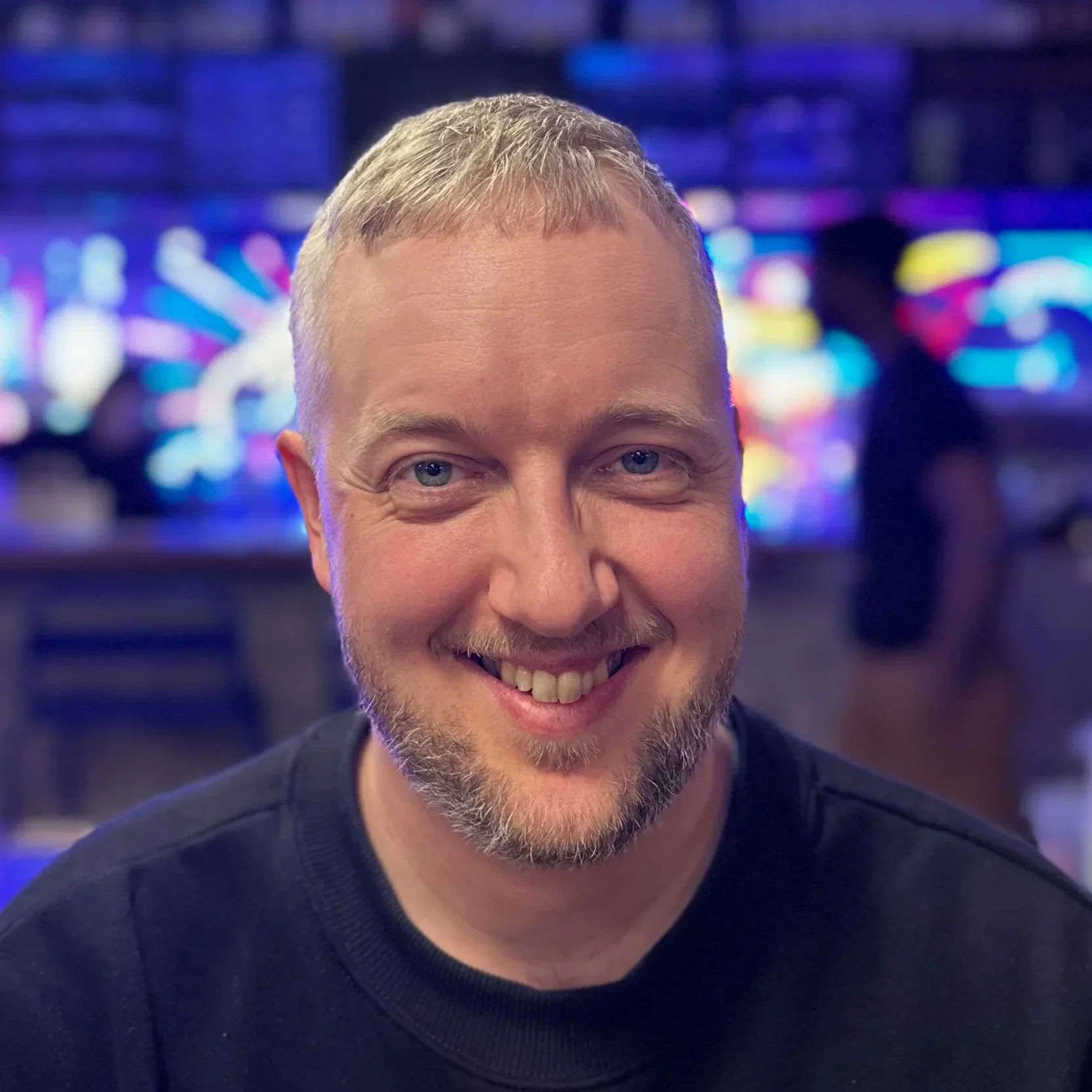 A portrait image of Ola Möller smiling at the camera.