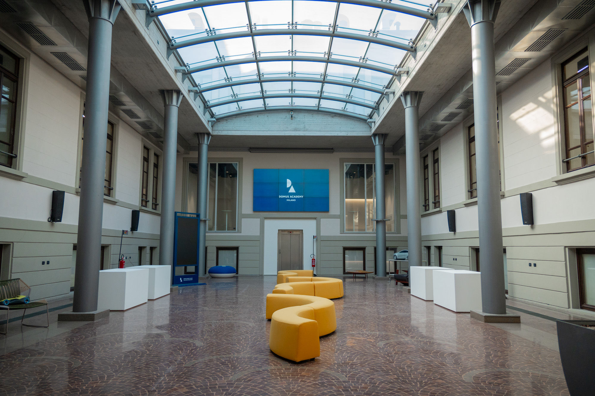 Domus Academy Milano's lobby showcasing their atrium/skylight.