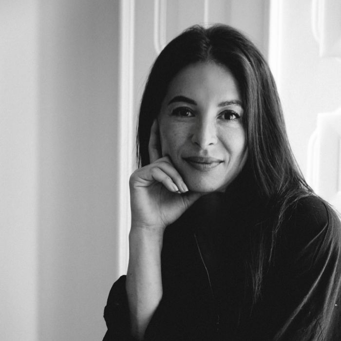 A grayscale portrait image of Julia Wysokowsky smiling at the camera.