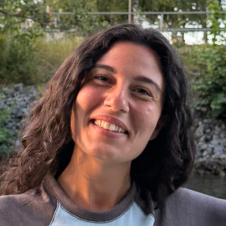 A close up portrait image of Julia Sakaberg, smiling at the camera.