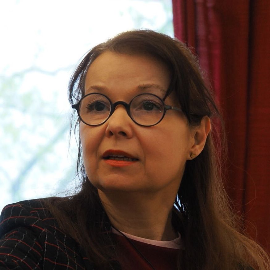 A close up portrait of Teodora Tzankova wearing glasses, looking in the distance.