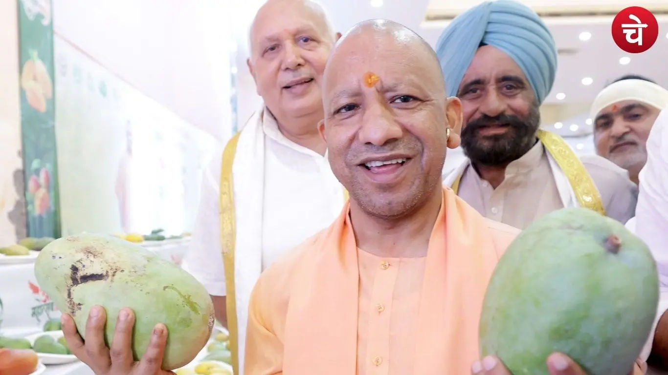 CM Yogi smiling while holding a mango