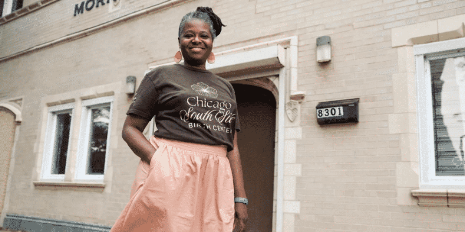 Jeanine Valrie Logan standing in front of a building that will be the Chicago South Side Birth Center