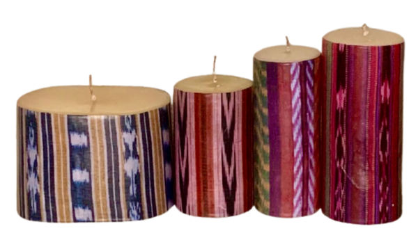 A lineup of Guatevelas candles: one short ovular candle followed by three cyllindrical candles of increasing height