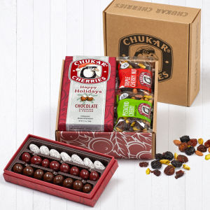 Open box of chukar cherries holiday classic gift box showing packaging and contents for Happy Holidays Cherries and Pecans Classic Assortment, Pistachio Cherry, and Triple Cherry Nut