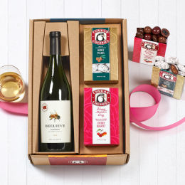 Open wine box showing product in packaging with wine poured in glass, open boxes and cross-sections of Honey Pecans and Mother's Day Cherry Quartet.