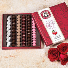 Open valentine's day original assortment showing six rows filled with chocolate covered cherries, nuts, and berries.
