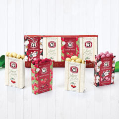 Easter sampler with two open boxes of white chocolate tart cherries, one raspberry truffles, and one cherry blossoms