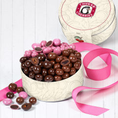 Open gift tin with product inside and cross-sections of cherry blossoms, classic milk cherries, and classic dark cherries.