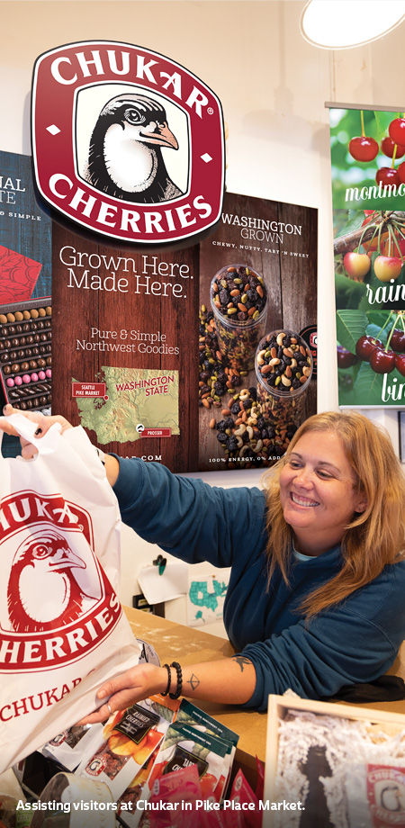 Chukar Cherries assisting visitors in Pike Place Market