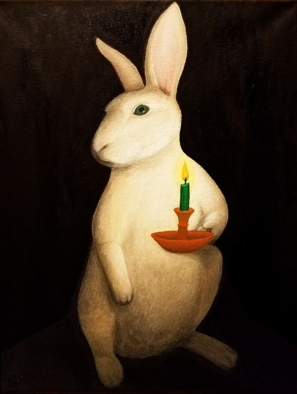 white rabbit holding a candle