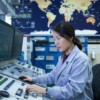 A dedicated engineer monitors real time grid data in a transmission control center, ensuring stability and efficiency in the power network.