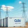 Engineers at work Monitoring CLOU's energy storage solutions amidst towering electricity infrastructure