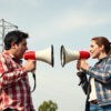 Clearing the Air Two enthusiasts discuss the challenges of crosstalk in power line communications, using megaphones to amplify their voices—just like managing signals!