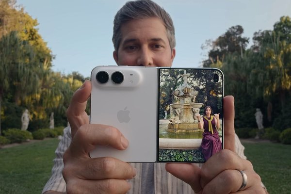 No, you wont be able to play two videos at once on iPhone Duo