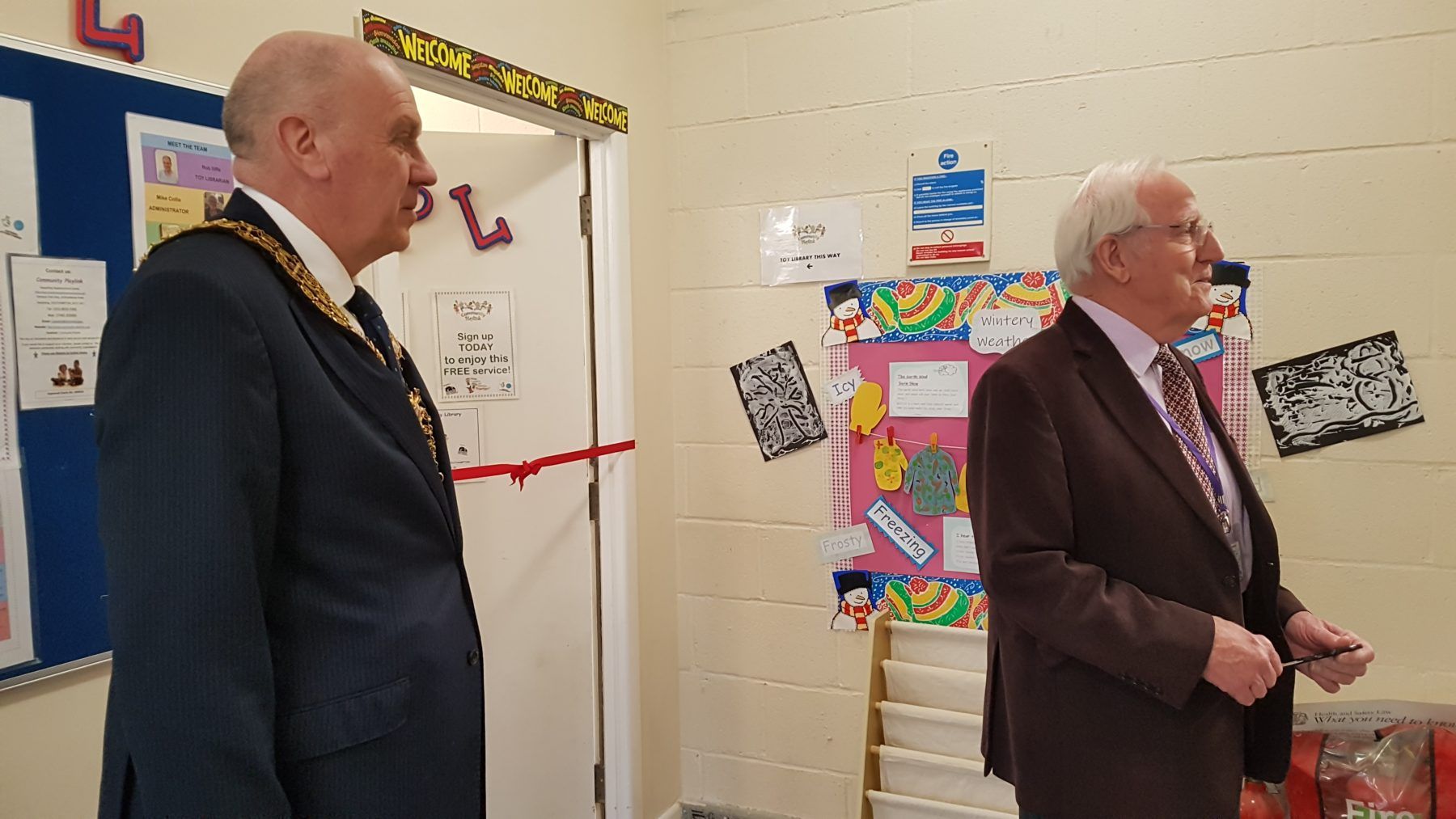 Our chairman, Richard Maunder, introduces the Mayor, Stephen Barnes-Andrews, at the opening ceremony for our new premises. They are stood outside the front door, with a red ribbon stretched across the doorframe.