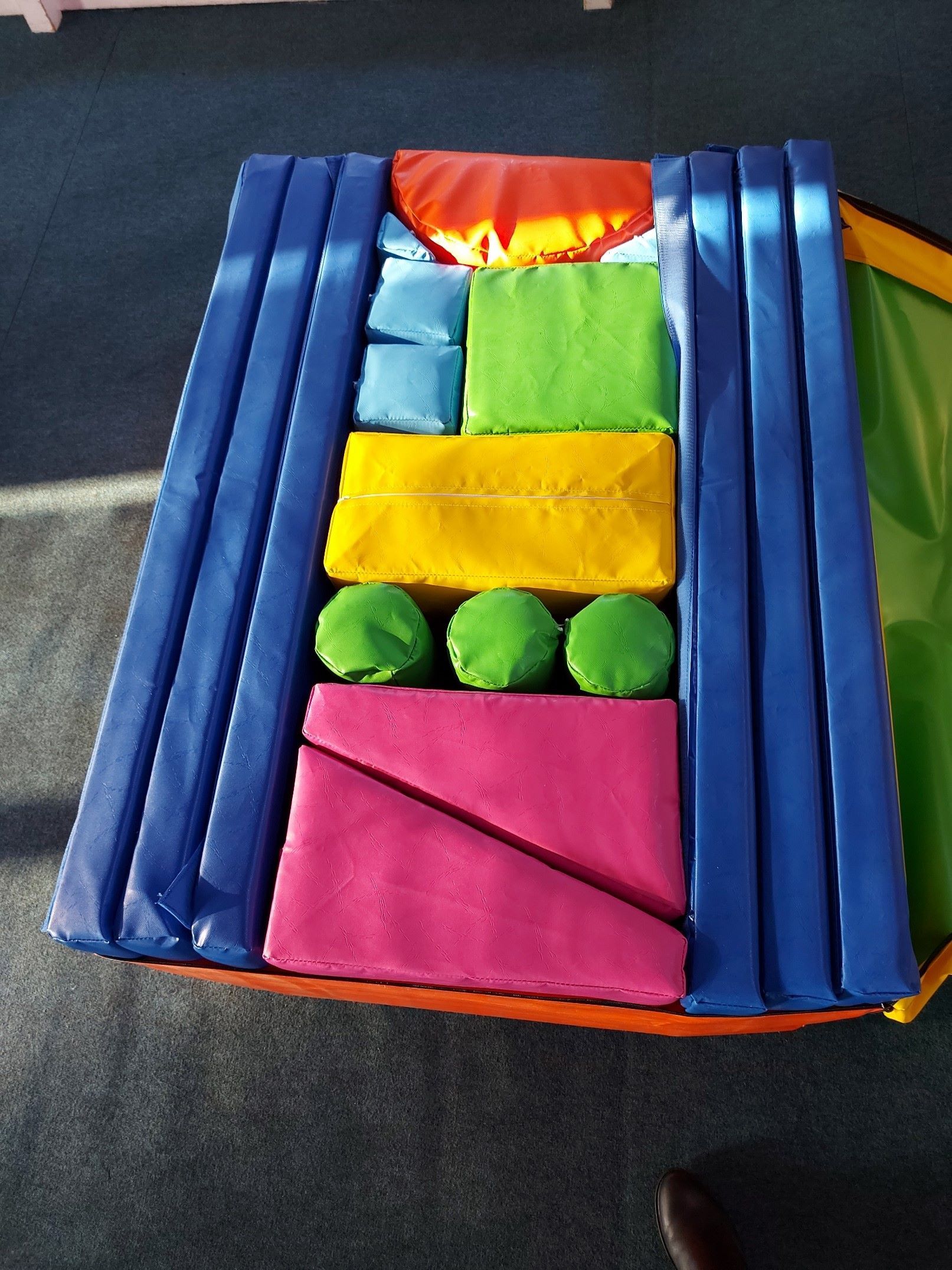 A large bag of soft play equipment with mats