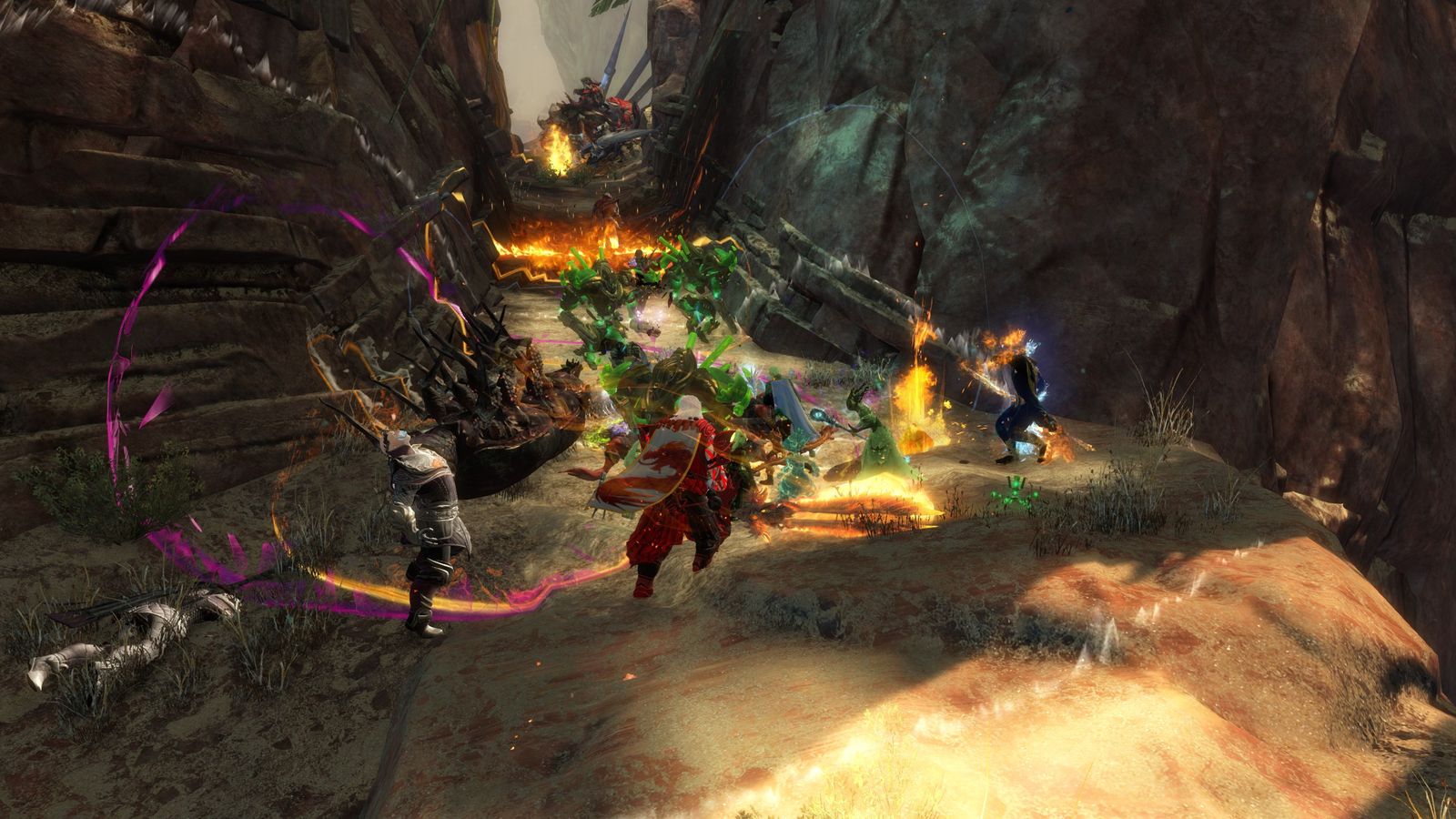 A small group fight in a rocky canyon in Guild Wars 2, with overlapping skill effects