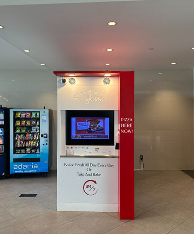 An indoor pizza vending machine in a bus terminal.